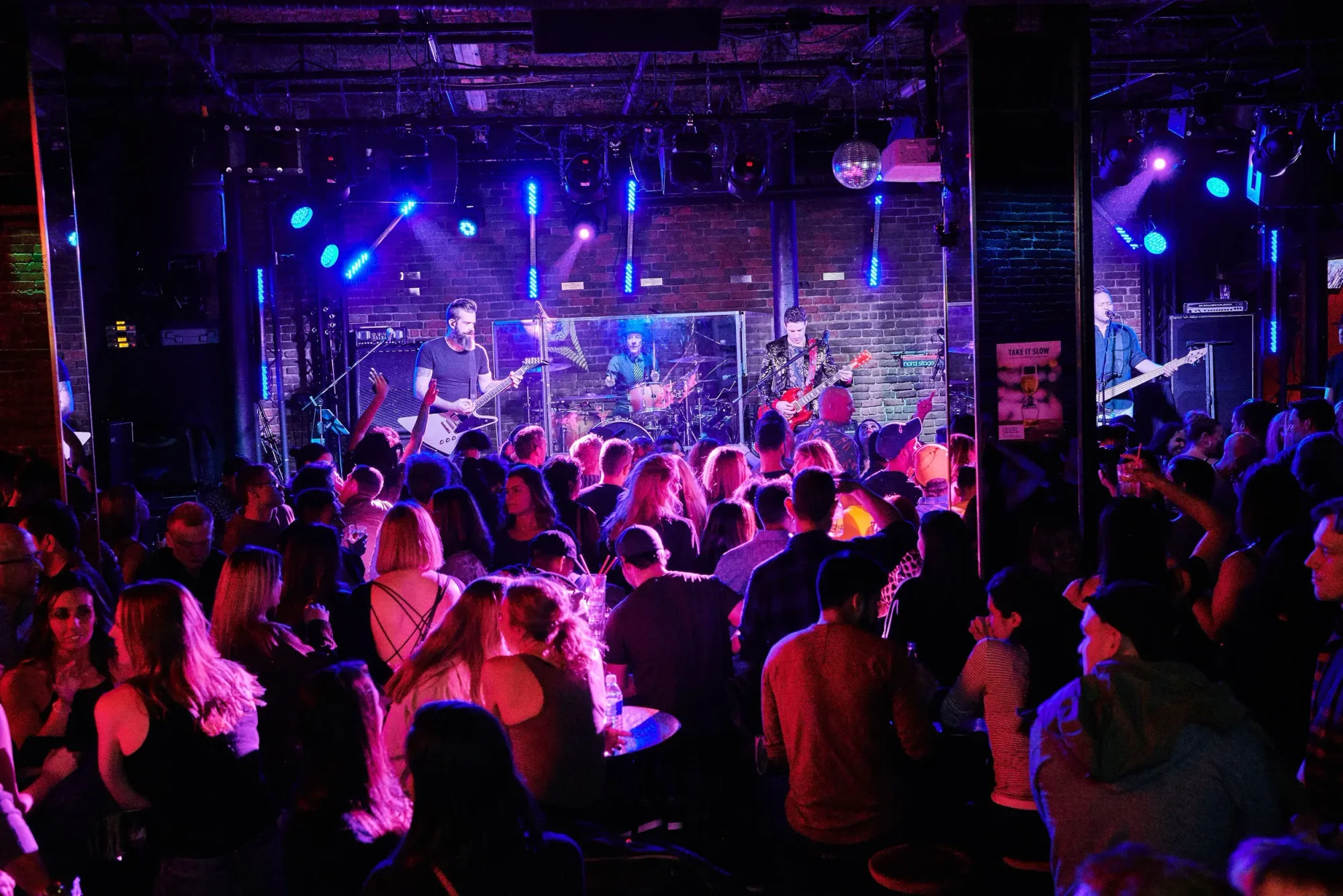 The Roxy Cabaret — packed dance floor, live band, neon signage