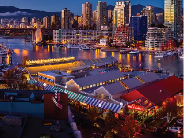Granville Island — public market stalls, produce, boats beyond