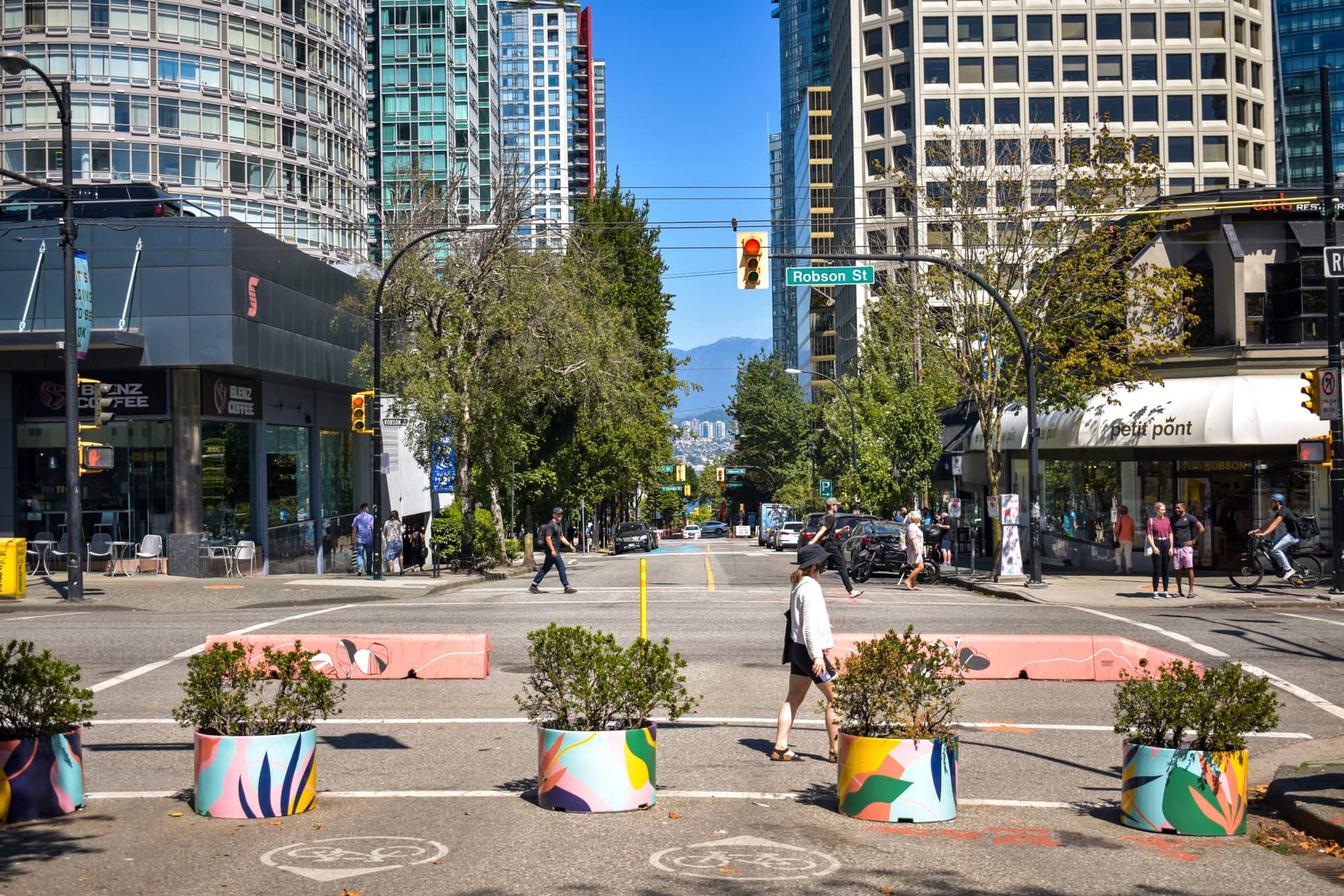 Robson Street — flagship storefronts, shoppers, evening lights