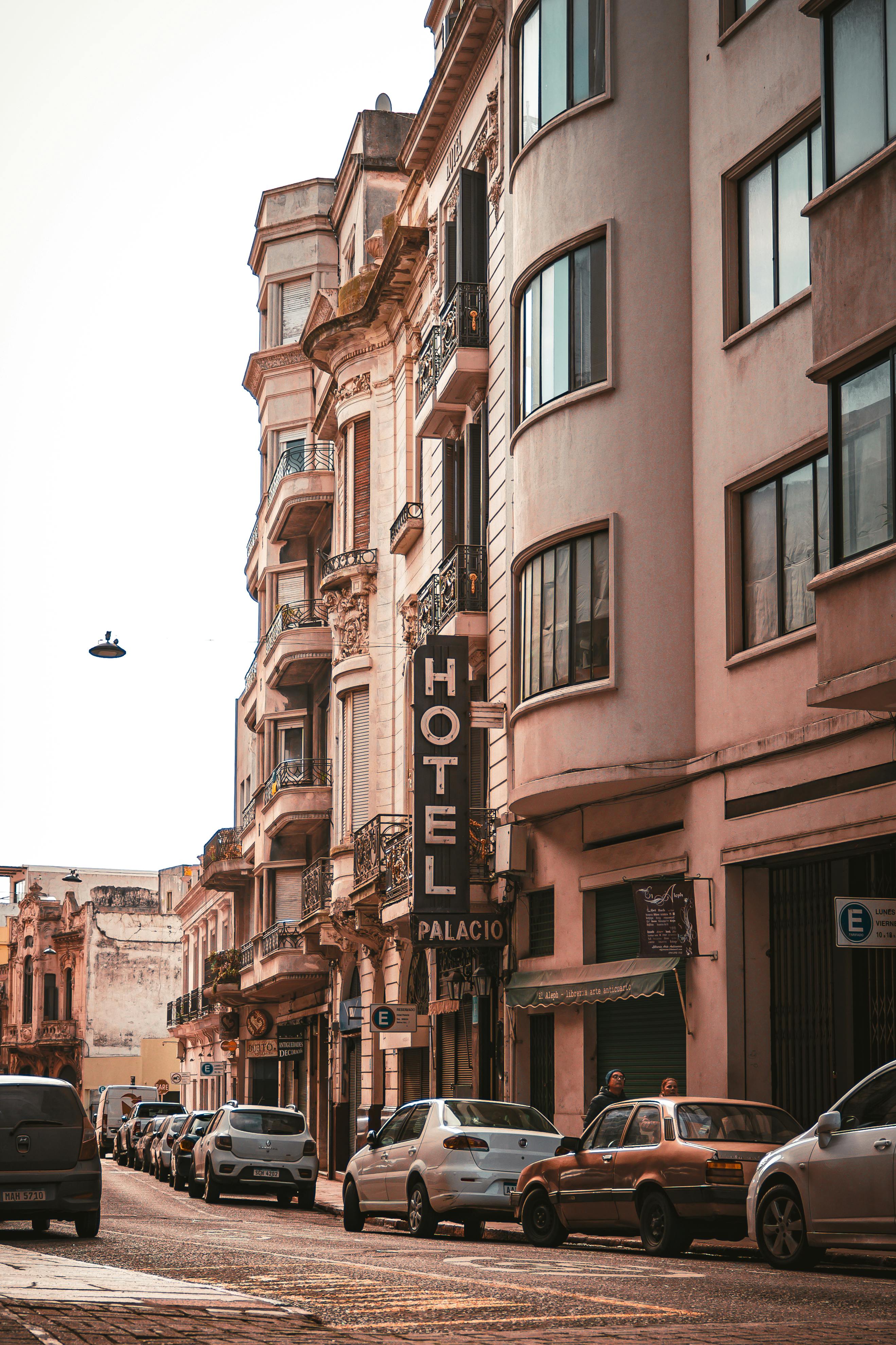The street — heritage hotel sign, cobblestone below